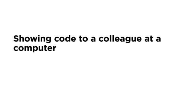 Showing code to a colleague at a
computer
